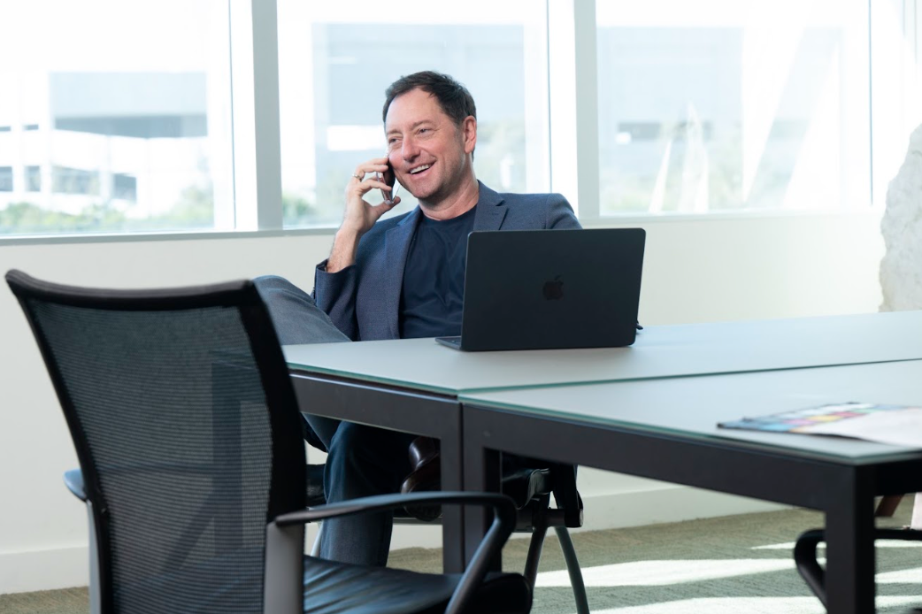 Michael Peterman on a phone call at his office desk
